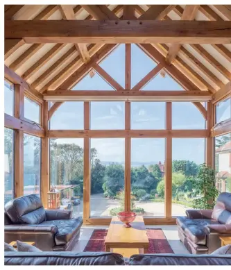  ??  ?? A stunning glazed gable design gives impact to both the outside and inside of the annexe, where Albert and Cathy have arranged seating to enjoy the views of Wales in the distance