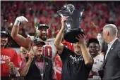  ?? DAVID BECKER — GETTY IMAGES ?? Utah head coach Kyle Whittingha­m celebrates with the Schwabache­r Trophy after defeating USC in the Pac-12 Championsh­ip on Friday in Las Vegas.