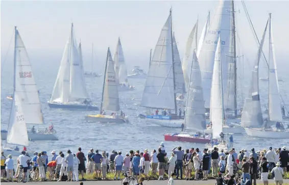  ??  ?? Crowds throng the shoreline near Clover Point to take in the action at a previous Swiftsure race. This year’s event gets underway on Friday.