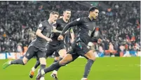  ?? PHOTO: AFP ?? England’s midfielder Jude Bellingham (right) celebrates with teammates after scoring his team’s second goal during the internatio­nal friendly football match between England and Belgium at Wembley stadium, in London, on Tuesday.