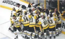  ?? Patrick Smith, Getty Images ?? The Penguins celebrate after defeating the Predators to win the Stanley Cup last season.