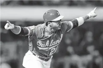  ?? Ben Margot / Associated Press ?? Oakland’s Ramon Laureano celebrates after his walkoff single against the Tigers in the 13th inning Aug. 3, the outfielder’s first game with the Athletics.