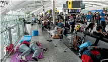  ?? PHOTO: GETTY IMAGES ?? People sleep on a blanket at Heathrow’s Terminal 5 after a British Airways IT failure caused the airline to cancel most of its services.