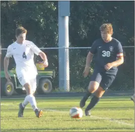  ?? STAFF PHOTO BY ANDY STATES ?? La Plata’s Owen Butler, left, attempts to work the ball past Northern’s Bryce Leslie during the teams’ game at Northern on Friday afternoon. Northern defeated La Plata 1-0 in overtime.