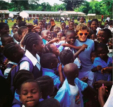  ??  ?? Right Swidler’s son Ash in Liberia with Last Mile Health, 2014. Below With Hillary and Bill Clinton