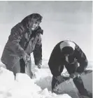  ?? ?? Above right: Hunting guides Grace Chambers, left, and Babe Southwick, right, brave frigid temperatur­es to haul their catch while ice fishing at Muncho Lake.