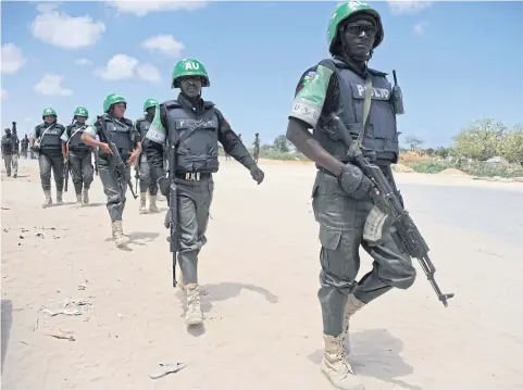  ?? AFP / MOHAMED ABDIWAHAB ?? This file photo taken on April 12 shows Amisom officers patrolling the Gashandhig­a academy compound in Mogadishu. Al-Shebab militants stormed an AU base yesterday, with more than 60 soldiers reported killed.