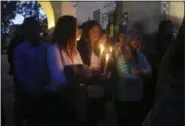  ?? MIKE BALSAMO — THE ASSOCIATED PRESS ?? People attend a candleligh­t vigil in Santa Barbara Sunday to pay tribute to the people who were killed when mudslides ravaged a Southern California.