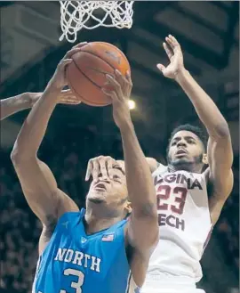  ?? Matt Gentry/AP ?? KENNEDY MEEKS of North Carolina is fouled by Jalen Hudson of Virginia Tech in the second half. The Tar Heels won the Atlantic Coast Conference game, 75-70.