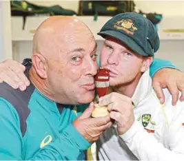  ??  ?? Australian skipper Steve Smith celebrates with head coach Darren Lehmann