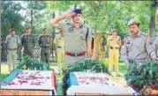  ?? WASEEM ANDRABI/HT ?? Security personnel pay tribute to slain J&K cops Ghulam Hassan and Ghulam Rasool in Pulwama on Tuesday.