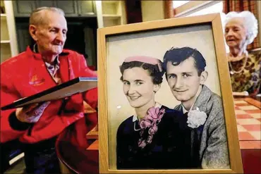  ?? FRED SQUILLANTE / THE COLUMBUS DISPATCH ?? Bud and Audrey St. Clair are pictured at the Senior Star Dublin Retirement Village on Tuesday as well as in a photograph from their wedding day. Bud has dementia and is in the memory ward at Senior Star. Audrey moved in too, even though she doesn’t have dementia.