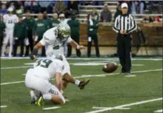  ?? SUE OGROCKI — THE ASSOCIATED PRESS ?? South Florida placekicke­r Coby Weiss (24) boots a field goal as punter Trent Schneider (39) holds in the first half of an NCAA college football game against Tulsa in Tulsa, Okla., Friday.