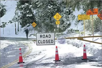  ?? Raul Roa Los Angeles Times ?? THE ROAD to Mt. Baldy was closed at Angeles Crest Highway on Monday. “Nobody is going up there with any ill intentions,” said the commander of a rescue squad about climbers. “There’s just a lack of awareness.”