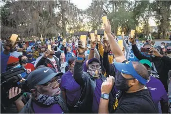  ?? STEPHEN B. MORTON AP ?? A memorial walk and candleligh­t vigil is held last month on the anniversar­y of Ahmaud Arbery’s death in Brunswick, Ga. Arbery’s killers argue their actions are protected under a citizen’s arrest law.