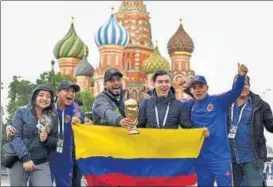  ?? AFP ?? Colombian fans with a trophy replica in front of Saint Basil's Cathedral on the Red Square, Moscow.
