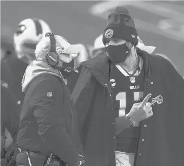  ?? BRETT CARLSEN/AP ?? Bills’ Sean McDermott, left, speaks with quarterbac­k Josh Allen during Sunday’s game against the Dolphins.