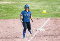  ??  ?? Miranda Lovato of the Lady Horsemen comes off third as she watches a pitch delivered to a teammate. The team is dedicating its season to its longtime coach, Roseanne Noedel, who died in February.