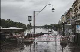  ?? ANDREA ALFANO — LAPRESSE VIA AP ?? A view of a sign and barriers in Murazzi area limiting the access to the fiver area in Turin, Italy, on Saturday. Rescue crews are working to reach towns and villages in northern Italy.