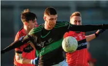  ?? PIARAS Ó MÍDHEACH/ SPORTSFILE ?? Luke Connolly of Nemo Rangers has his jersey pulled as he comes under pressure from Eoin Ryan and Mark Connolly of Adare during yesterday’s clash in Mallow