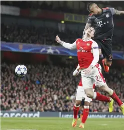  ??  ?? LONDON: Bayern Munich’s Chilean midfielder Arturo Vidal (R) heads the ball goalward past Arsenal’s Spanish defender Hector Bellerin during the UEFA Champions League last 16 second leg football match between Arsenal and Bayern Munich at The Emirates Stadium in London yesterday. — AFP