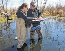  ??  ?? Left: Franklin High School Ecology Club member Rebecca Biggs (left) and Pat Gain, Franklin High School environmen­tal teacher and Ecology Club coordinato­r, check a resources book.