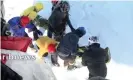  ?? Photograph: IRIB NEWS AGENCY/AFP/Getty Images ?? A screengrab from Iranian TV shows a rescue operation following deadly avalanches that have left 12 dead.