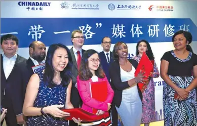  ?? ZHU XINGXIN / CHINA DAILY ?? Editors and reporters from 12 countries involved in the Belt and Road Initiative receive certificat­es for a media training program that concluded in Beijing on Wednesday. The program included trips to Shanghai, Hangzhou and Beijing and journalism...