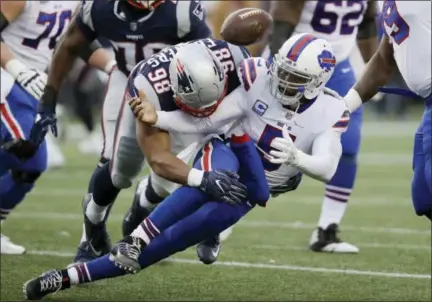  ?? CHARLES KRUPA — THE ASSOCIATED PRESS ?? Buffalo Bills quarterbac­k Tyrod Taylor fumbles as he is sacked by New England Patriots defensive end Trey Flowers (98) during the second half of an NFL football game, Sunday in Foxborough, Mass. The Bills recovered the ball.