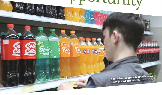  ?? Photo: VCG ?? staff checks A Russian supermarke­t shelves. items placed on