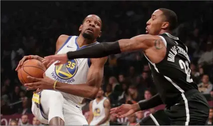  ?? AP PHOTO/FRANK FRANKLIN II, ?? In this 2018 file photo, Brooklyn Nets’ Caris LeVert (22) defends against Golden State Warriors’ Kevin Durant during the first half of an NBA basketball game in New York.