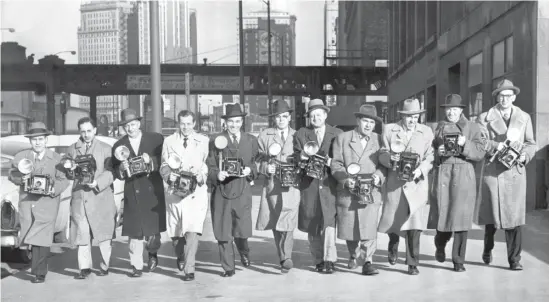  ?? SCAN PROVIDED BY THE CHICAGO HISTORY MUSEUM ?? Award-winning Sun-Times photograph­ers pose for a picture taken by Jack Lenahan that was published on March 9, 1956. From left: Louis Giampa, Larry Nocerino, Bill Pauer, Bob Kotalik, Carmen Reporto, Howard Lyon, Ralph Walters, Bill Sturm, Bill Knefel, Dave Mann and Joe Kordick.