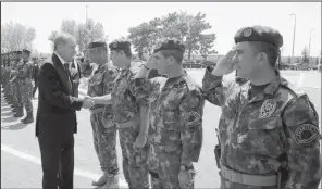  ?? AP ?? Turkey President Recep Tayyip Erdogan (left) visits Friday with officers of the police special forces at their headquarte­rs in Ankara.