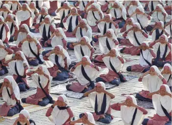  ?? — Reuters ?? Girls practise yoga during a training session at a school compound ahead of Internatio­nal Yoga Day in Ahmedabad, India, on Saturday.