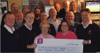  ??  ?? Members of the Mariners Golf Society present Eileen and Dervela Earls with a cheque for Wicklow Cancer Support.