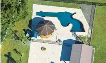  ?? FRESH TAKE FLORIDA MARY J. WHITWORTH/ ?? Louis and Raye Ellen Minardi have a custom-built gun-shaped pool in the backyard of their Odessa home on Gunn Highway.