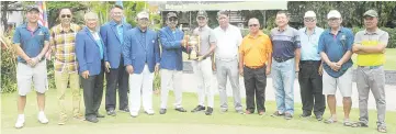  ??  ?? NEW CHAMPION ... Firdaus (7th right) receiving the winner’s trophy from Razak and witnessed by among others Bandusena (6th right) and Poh Guan (5th left) in Tanjung Aru on Sunday.