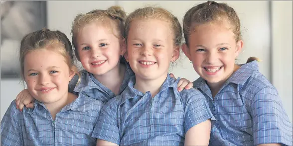  ??  ?? ALL ON THE BUS: From left, Sophia, grade two, Imogen, foundation, Trinity, grade four, and Chontelle Gerdtz, grade five, are ready for the new school year at Holy Trinity Lutheran College. Picture: PAUL CARRACHER