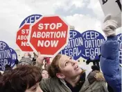  ?? GERALD HERBERT
AP ?? Both sides in the abortion debate protest in front of the U.S. Supreme Court in Washington, D.C., in 2004. Florida Gov. Ron DeSantis joined a legal brief that says two landmark abortion cases restrict states from governing an area that they should have control over.