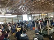  ?? COURTESY OF R.T. CUSTER ?? A crowd estimated at more than 100 gathers for the estate and farm equipment auction at DeLong Christmas Tree Farm on Monday, Dec. 28, 2020. The 42-acre property sold for $930,000.