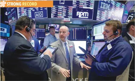  ?? — Reuters ?? Traders work on the floor of the New York Stock Exchange (NYSE) in New York.