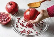  ?? SCOTT SUCHMAN/THE WASHINGTON POST ?? The best method for de-seeding pomegranat­es you ask: Why just whack them with a wooden spoon, it’s even therapeuti­c.