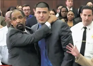  ?? WHDH-TV ?? In this still image from video, Aaron Hernandez (center) is hugged by defense attorney Ronald Sullivan after being found not guilty of murder in the 2012 shootings of two men.