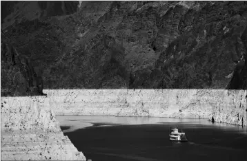  ??  ?? IN THIS 2015 file photo, a riverboat glides through Lake Mead on the Colorado River at Hoover Dam near Boulder City, Nev.