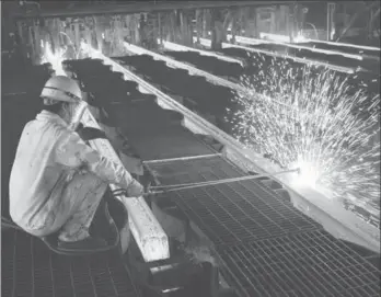  ?? SI WEI / FOR CHINA DAILY ?? A worker cuts steel bars on the production line of a mill in Lianyungan­g, Jiangsu province. The official manufactur­ing Purchasing Managers Index for June stood at 51, the fourth consecutiv­e month-on-month rise this year.