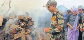  ?? AP ?? Son Ankush Choudhary stands near the funeral pyre of his father Subedar Madan Lal Choudhary, who was killed in Saturday's militant attack, in Jammu on Monday.