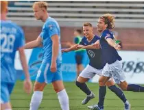  ?? STAFF PHOTO BY DOUG STRICKLAND ?? Chattanoog­a FC’s Juan Hernandez, right, and Mason Walsh celebrate Hernandez ’s goal against Asheville City FC at Finley Stadium on June 29.