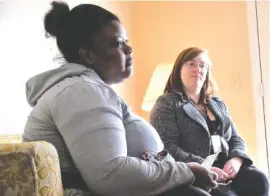  ?? STAFF PHOTO BY TIM BARBER ?? Shanairia Gaines, left, talks about receiving help from the Neediest Cases Fund with Samantha Strader, a Tennessee Department of Human Services representa­tive. Gaines now lives in an apartment away from the rat infestatio­n of her previous abode.