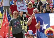  ?? Jason Fochtman / Staff photograph­er ?? Supporters of President Donald Trump cheer during a “Defend Our President” rally in Conroe in November.