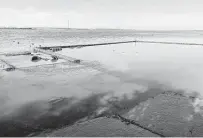  ?? Courtesy Harris-Galveston Subsidence District ?? The Brownwood subdivisio­n sank into Crystal Bay after water and oil were pumped from undergroun­d from 1943 to 1973.